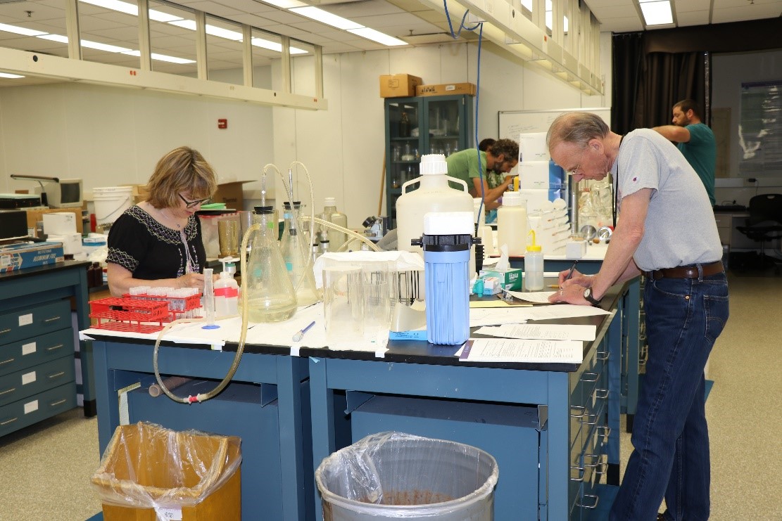 male and female scientists doing research at lab tables