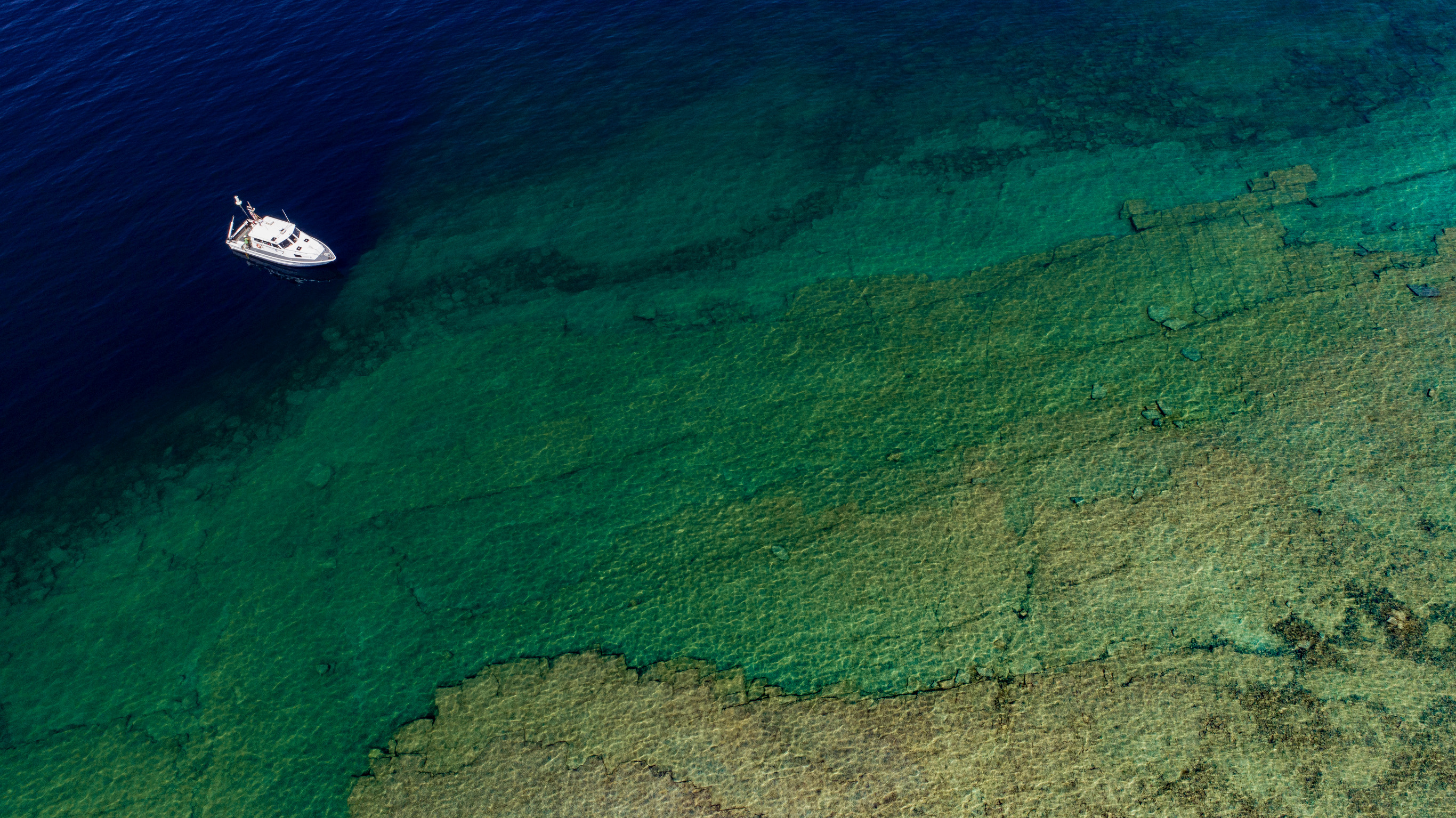Aerial view of research boat on green water