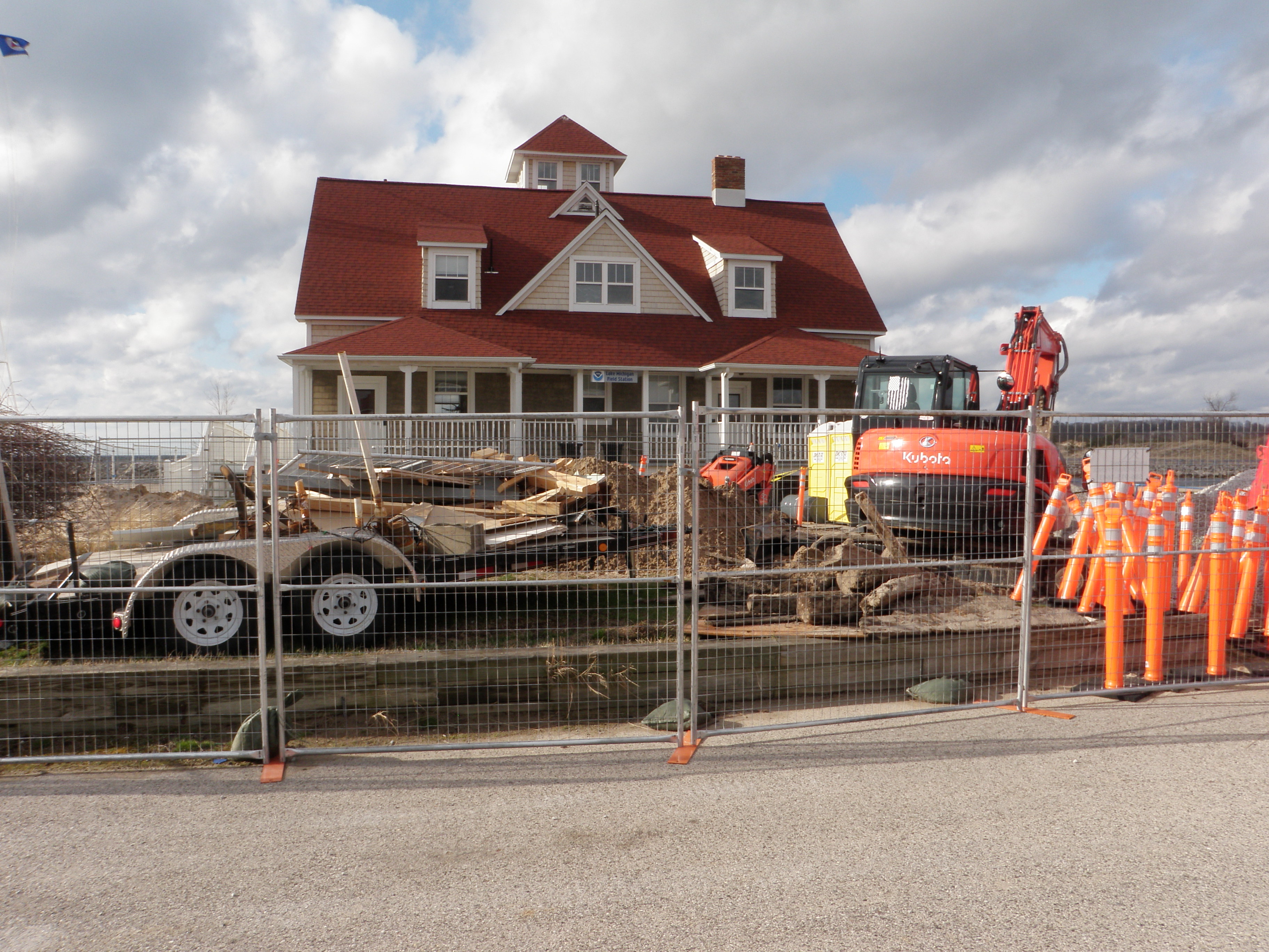 picture of buildig 1 at the Lake Michigan Field Station with trucks and a fence in front